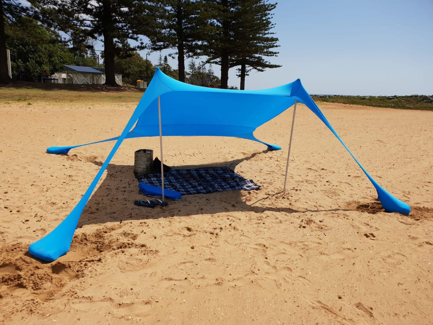 Oaken Sky Shores offers the Lycra Sky Shade Beach Tent: a lightweight, portable awning for ultimate sun protection. Easy to set up, it provides ample shade for beach days, camping, or any outdoor activity.